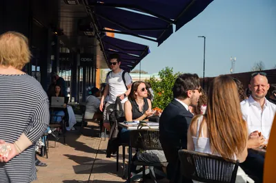 Customers eating outside on the Apex Lounge terrace