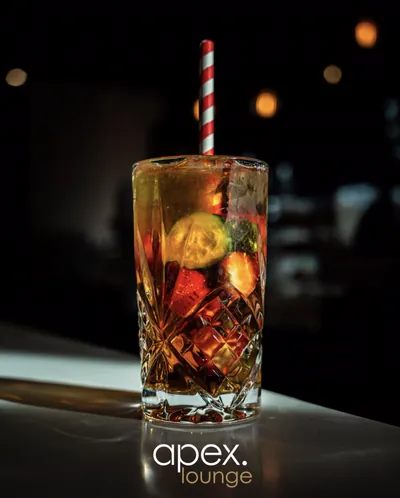 Fruit cocktail with a striped straw on the Apex Lounge bar